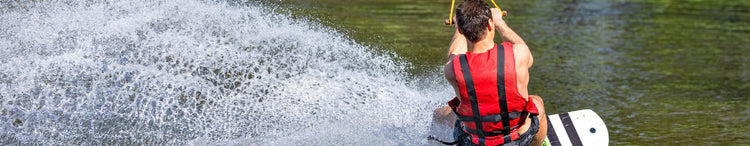 Man on a wakeboard riding a wave