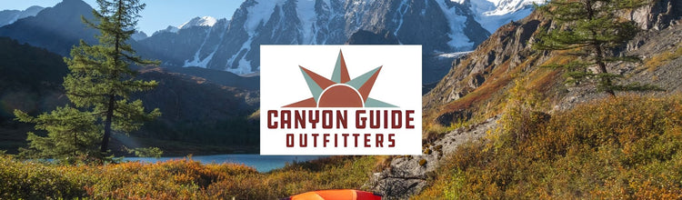 Canyon Guide Outfitters Logo on a snowy mountain with a orange tent