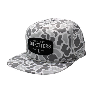 Local Boy Outfitters Perforated Flat Brim Hat with camo design, woven patch, and ventilated back