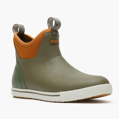 Green and orange rubber boot with white sole on a white background